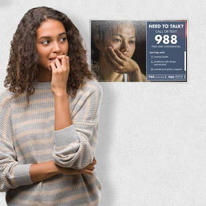 Concerned hispanic girl looking to the 988 Suicide and Crisis Lifeline poster